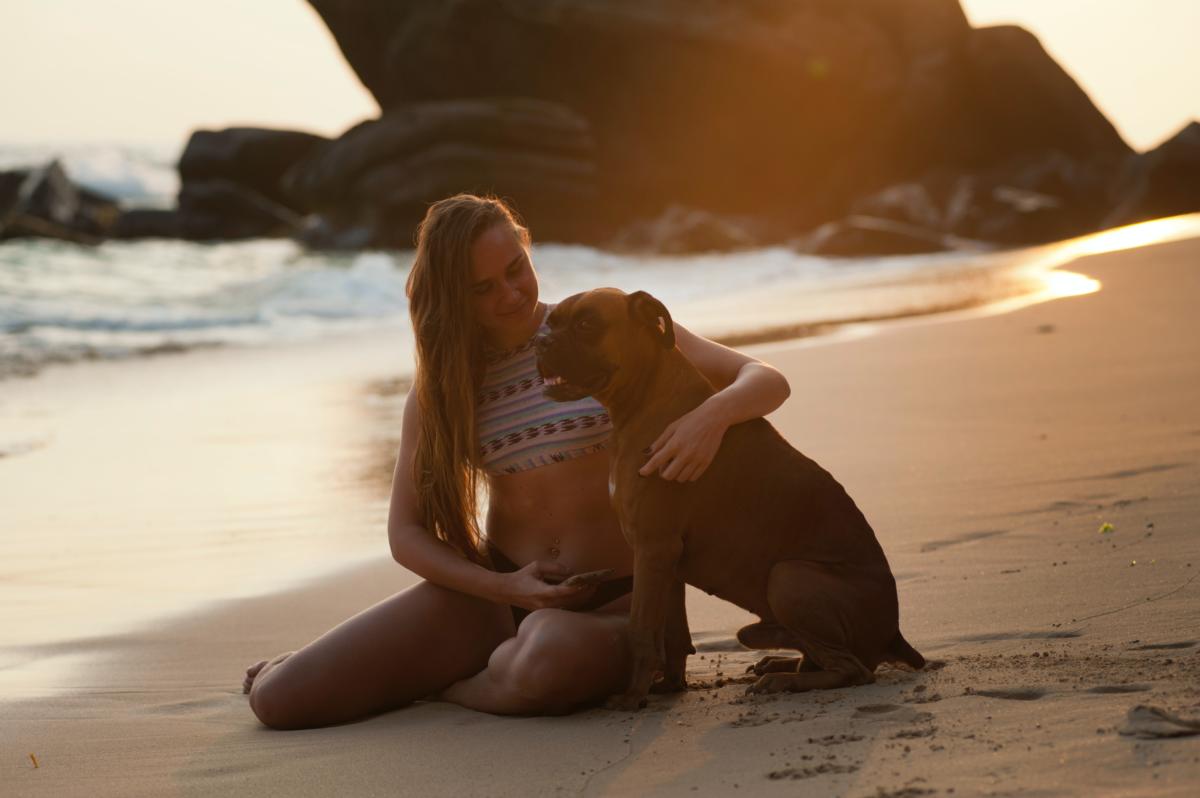 Dog and girl in beach